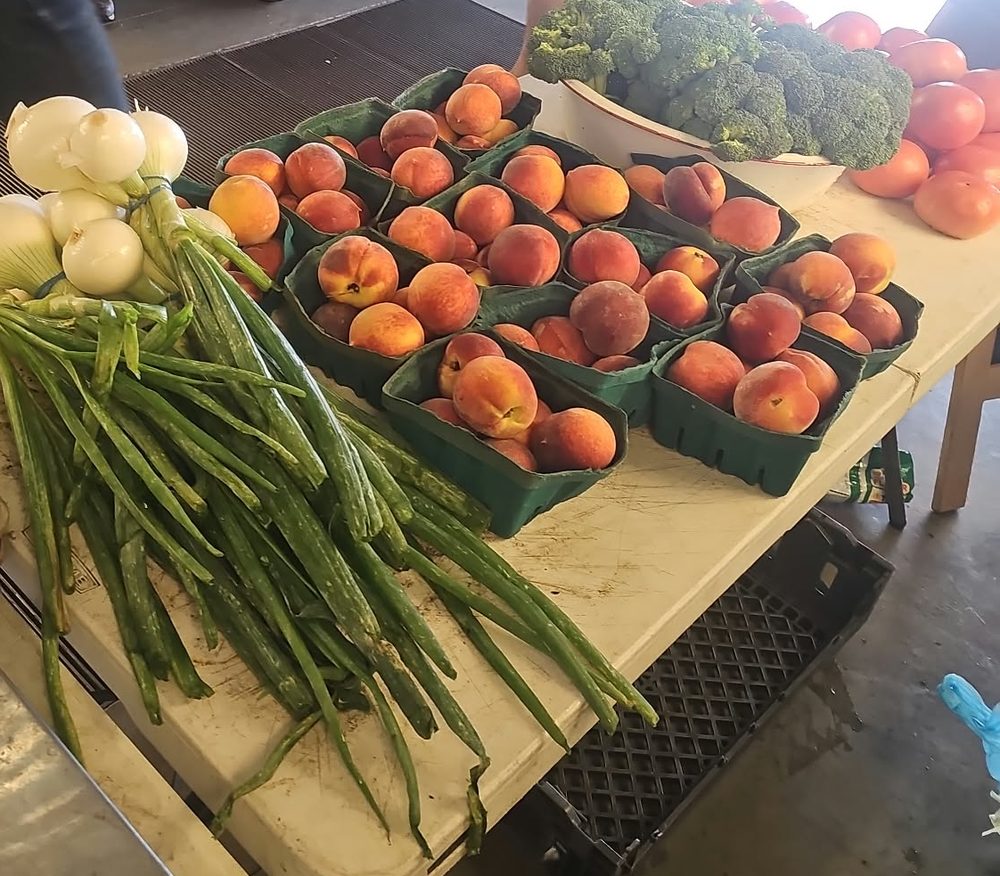 Peaches and green onions on the table