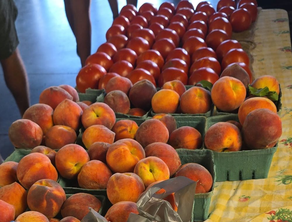 Peaches in baskets on the market table